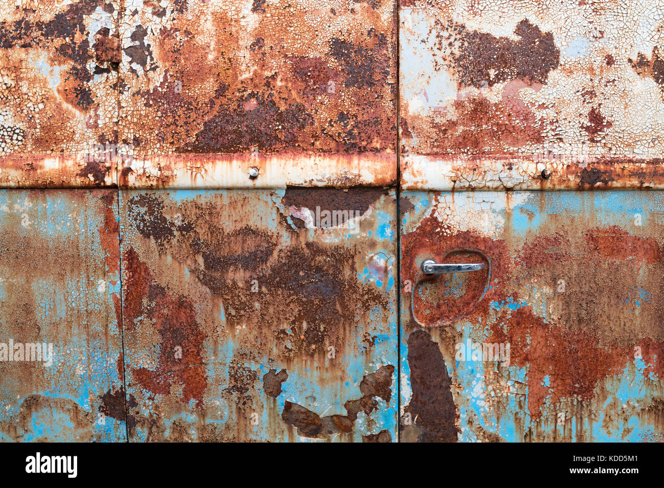 VW Volkswagen split screen panel van rusted metal side panel with cracked paint texture abstract. UK. Stock Photo