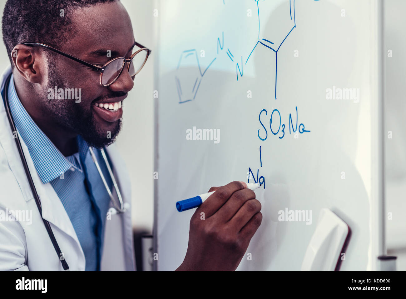 Excited African American medical worker drawing chemical drawing Stock Photo