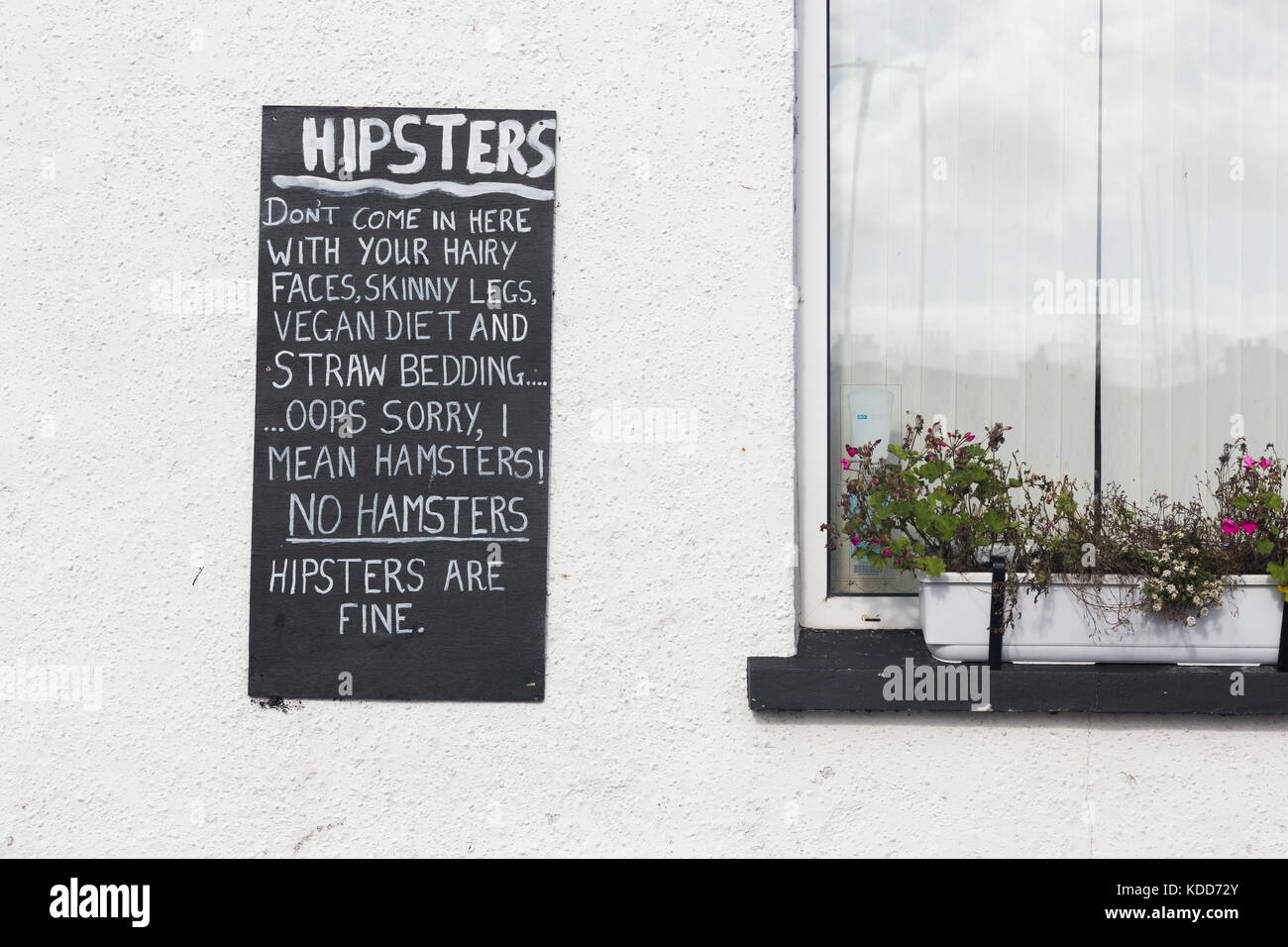 Funny sign outside pub confusing hipsters with hamsters Stock Photo