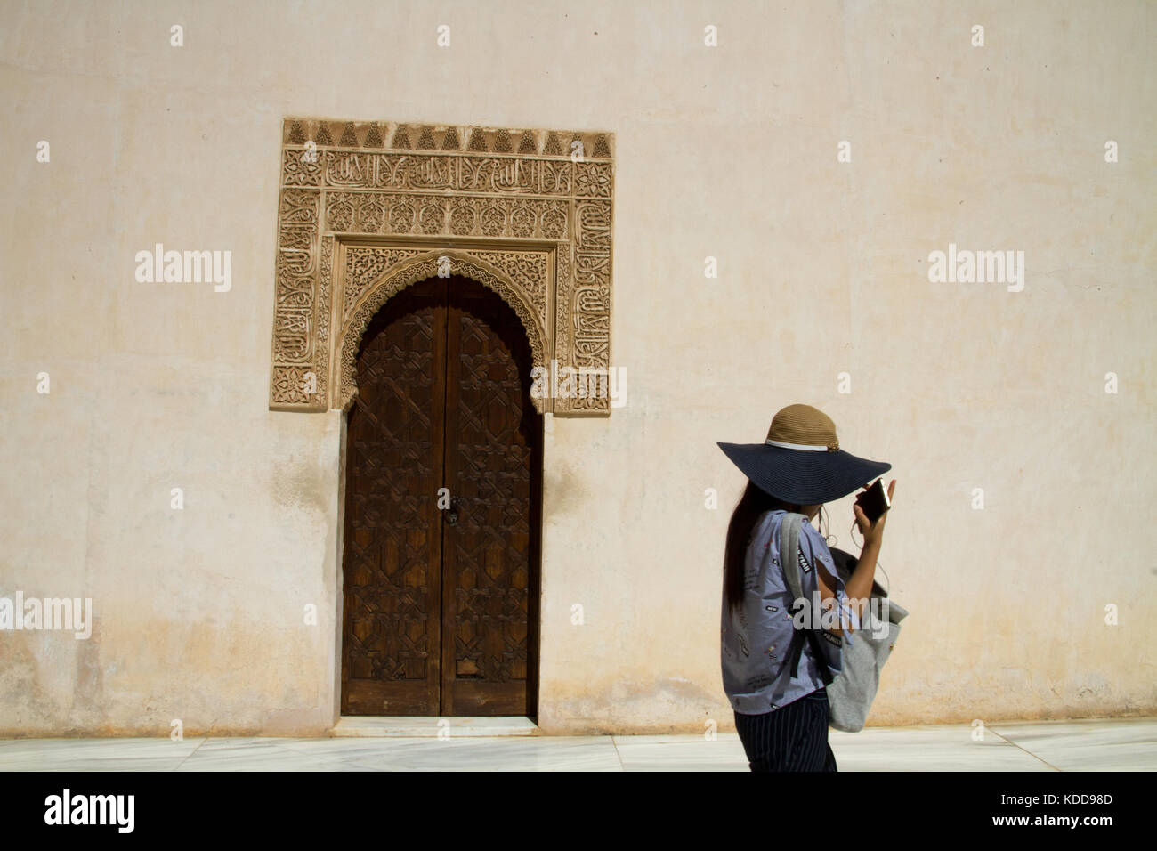 Alhambra Granada scene, tourist woman visiting arabic moorish architecture building. Andalusia Spain . Stock Photo
