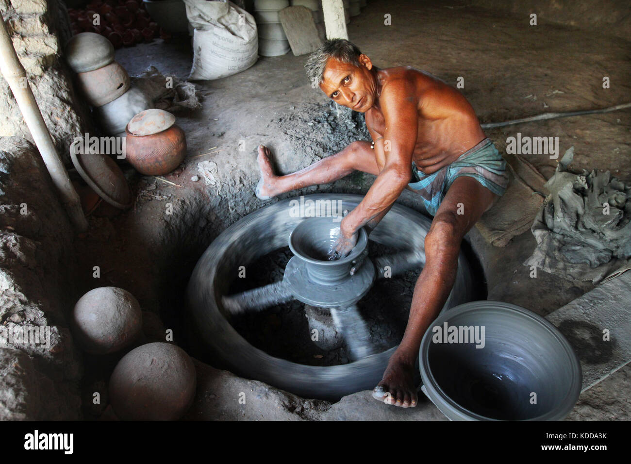 Khulna, Bangladesh Potter makes clay pot using a traditional wheel at