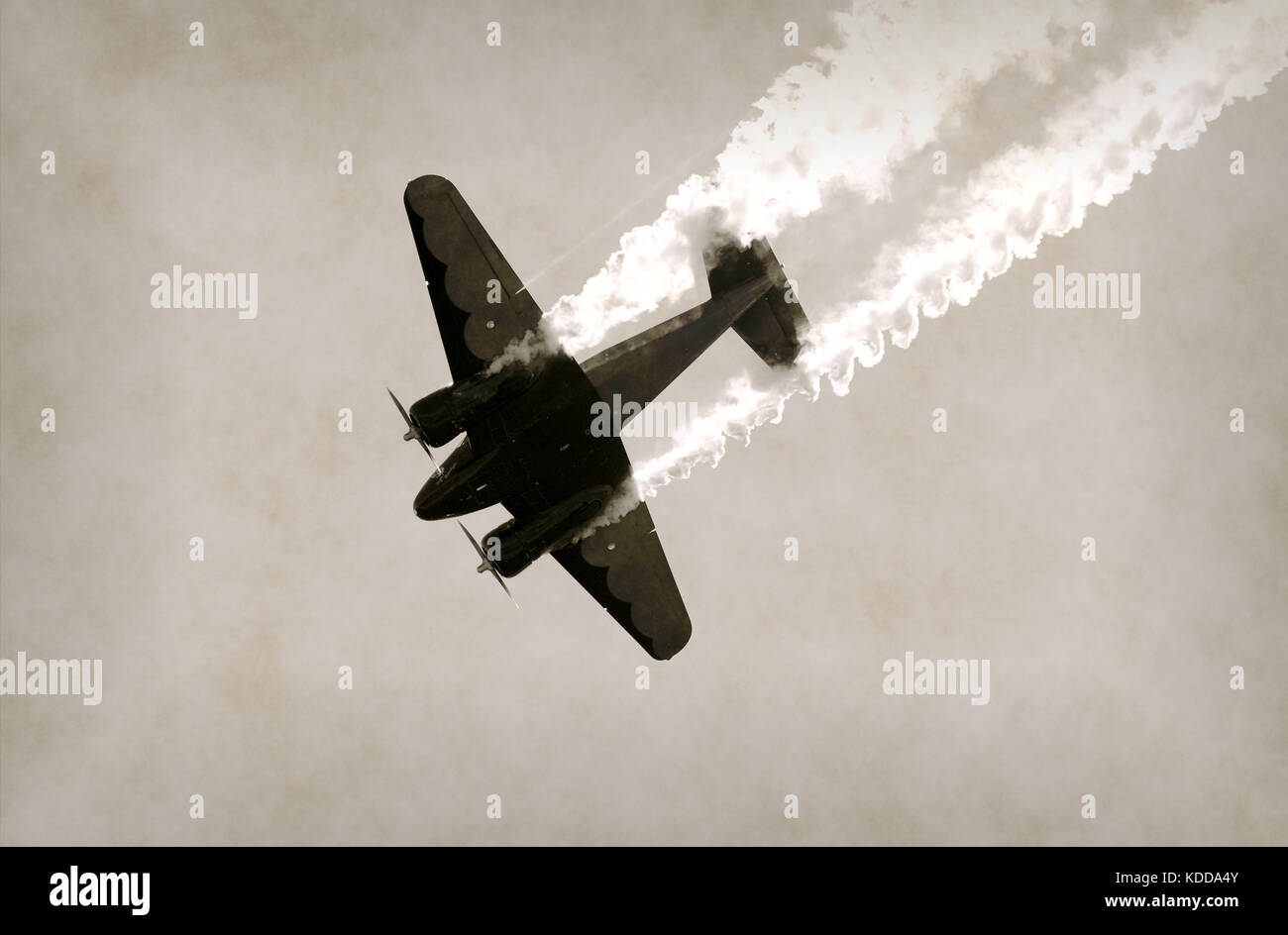 World War II era propeller airplane diving with a trail of smoke Stock Photo