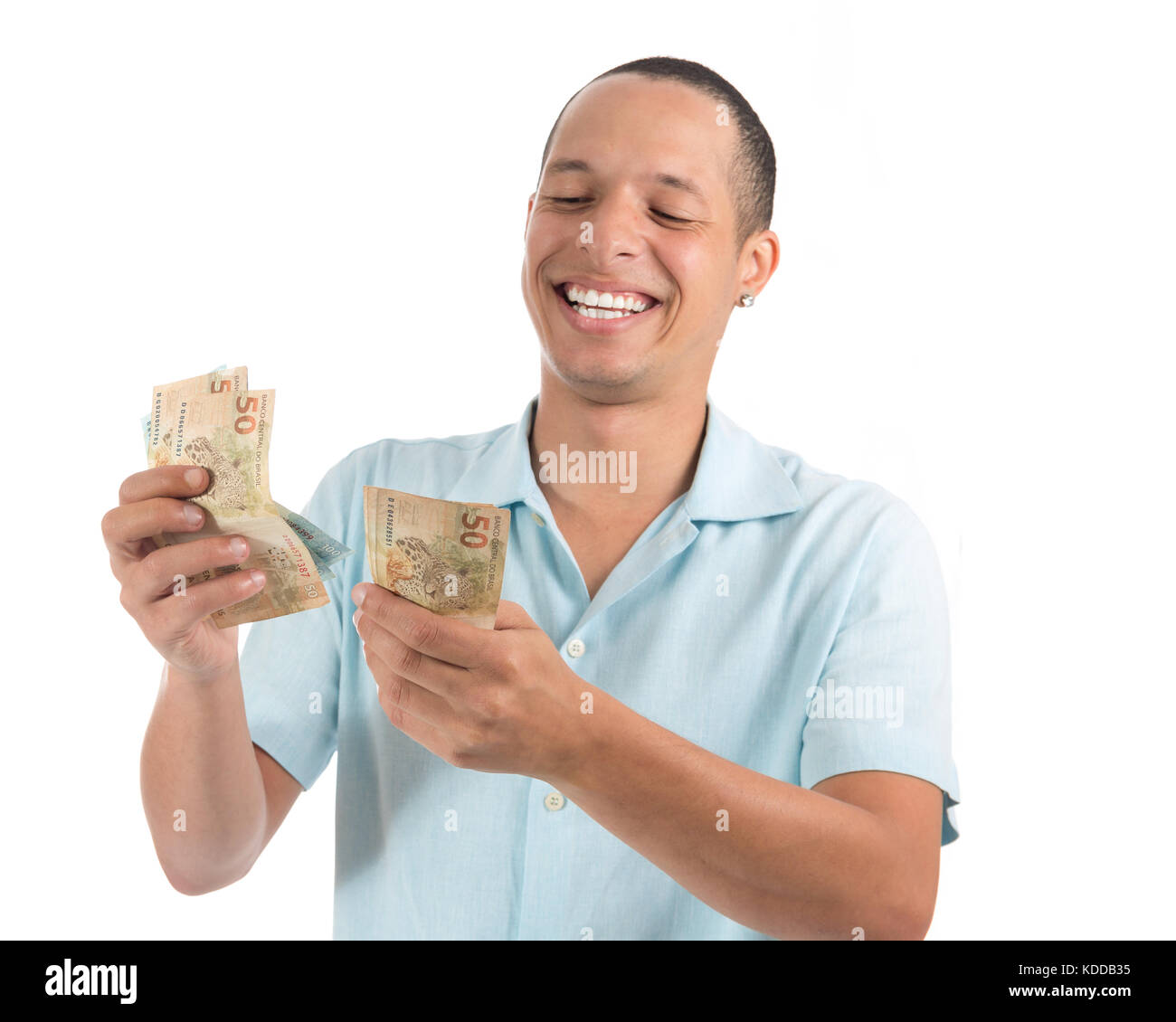 Brazilian currency. Man is counting money. Real. Young latin american