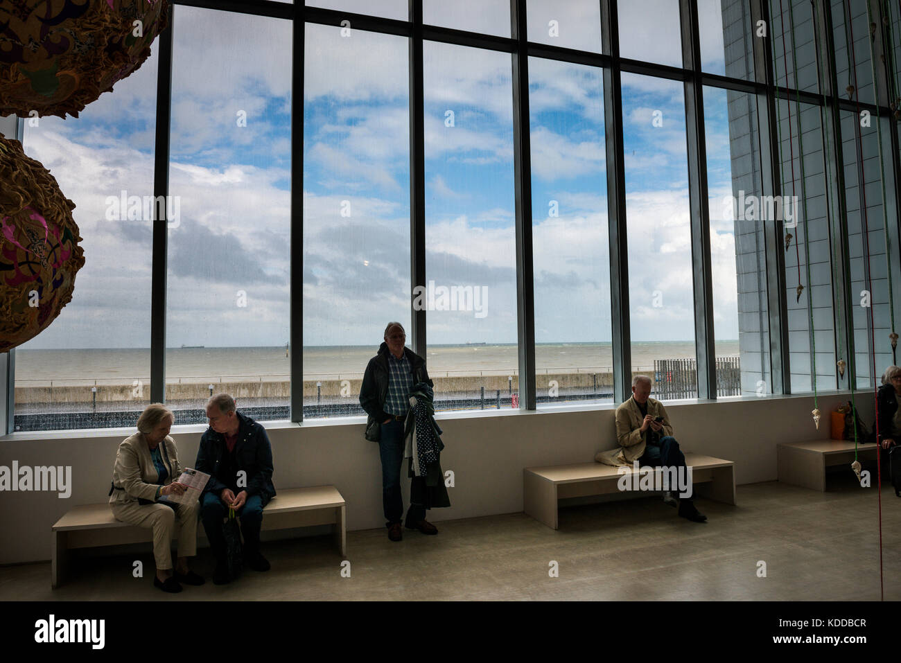 Art lovers sitting in the main entrance to the Turner Contemporary Art Gallery, Margate, UK Stock Photo