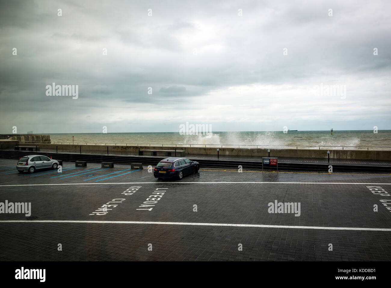 Waves breaking over a wall next to the Turner Contemporary Art Gallery, Margate, UK Stock Photo