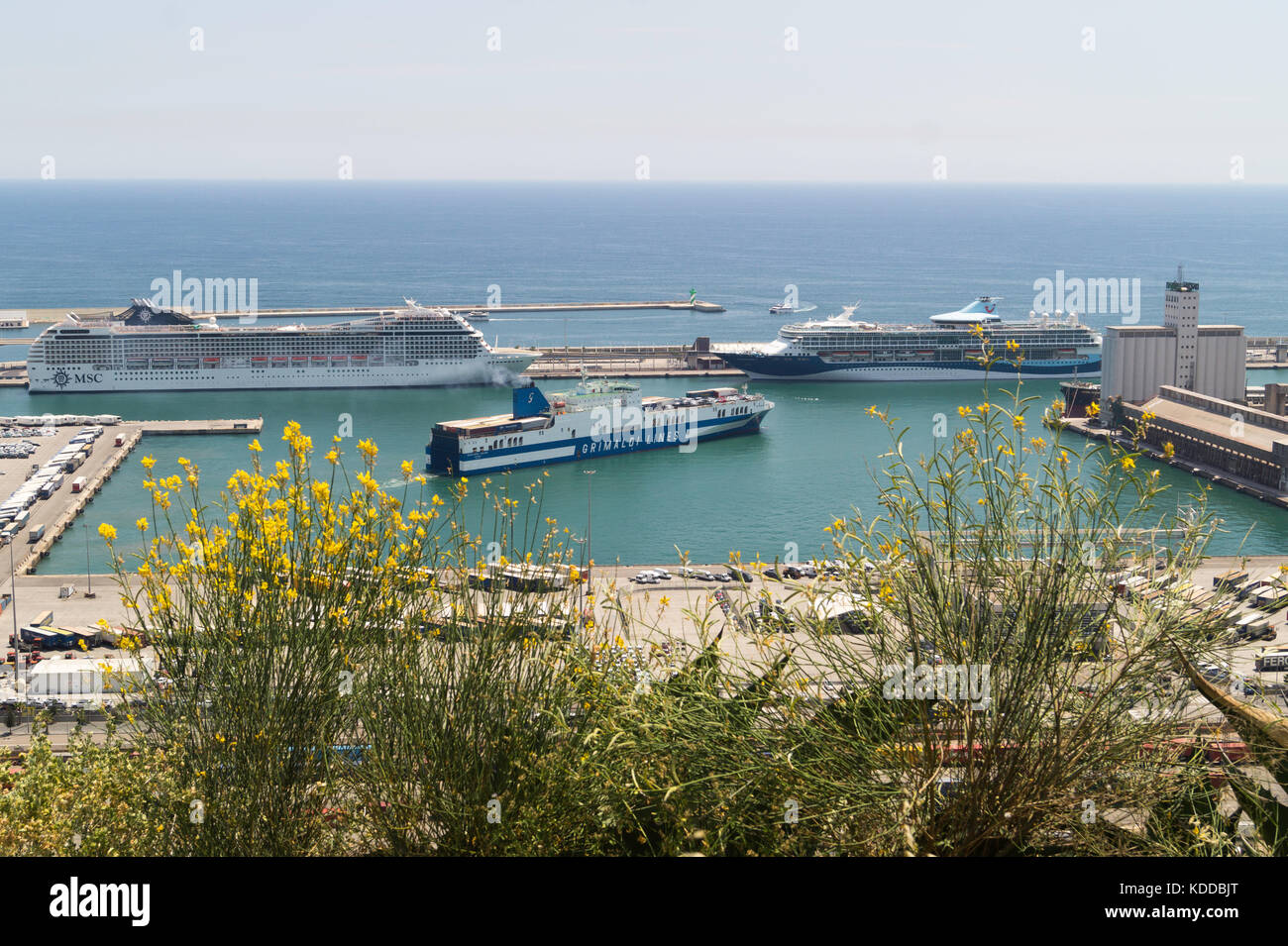 A ferry manoeuvering in the port of Barcelona with two Cruise ships behind, viewed from Montjuic Stock Photo