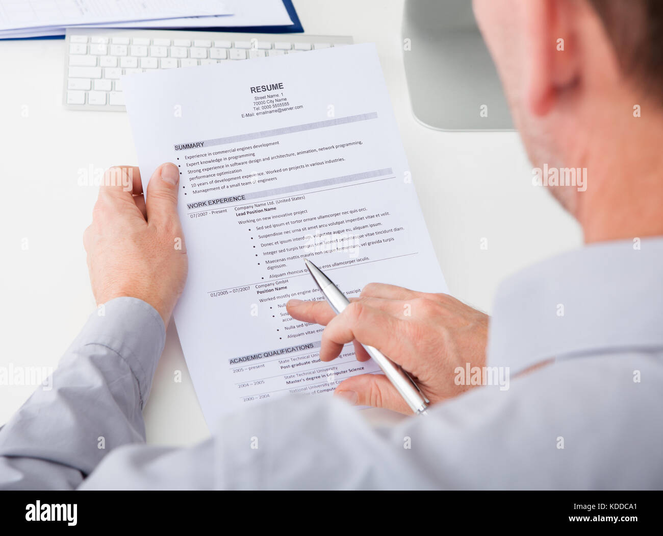 Close-up Of Person Hand Holding Curriculum Vitae Stock Photo
