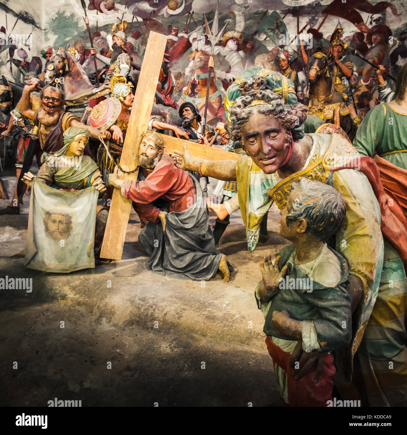 Via Crucis of Jesus Christ, in a Passion of Christ biblical scene a woman show his child a Jesus Christ bringing his cross before his Crucifixion Stock Photo