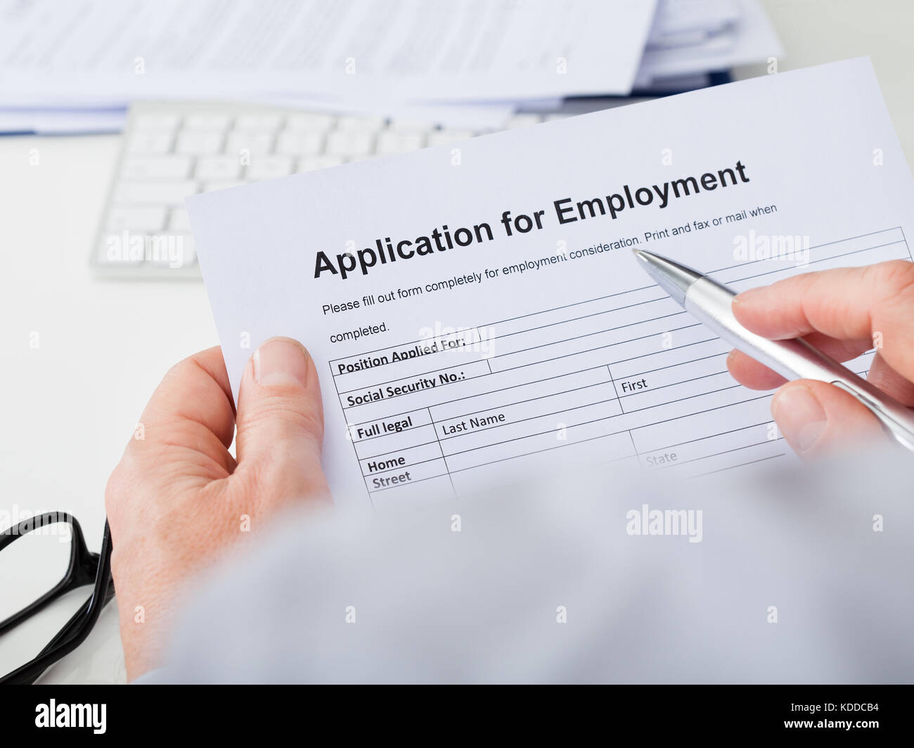 Close-up Of Hand Filling Application For Employment Stock Photo