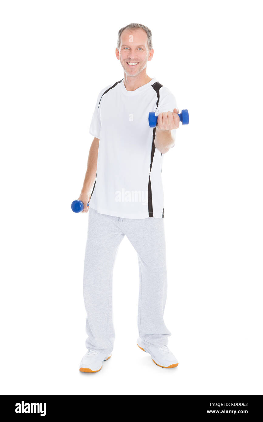 Mature Man Exercising With Dumbbells Over White Background Stock Photo