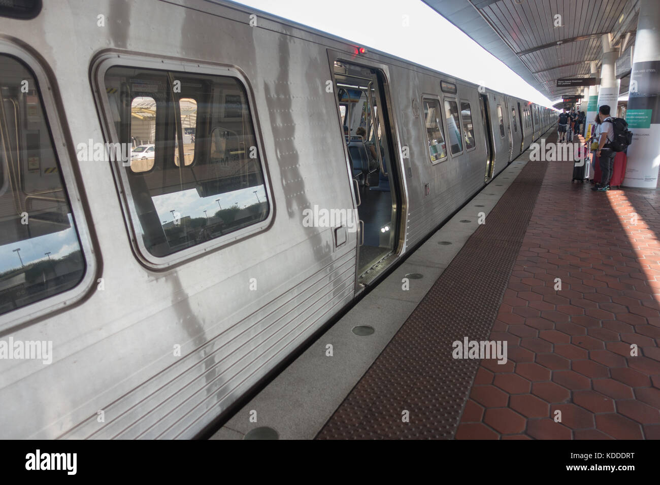 Washington, DC new Metro 7000-series train cars, outdoors Reagan National Airport Metro station, travelers on platform. Stock Photo