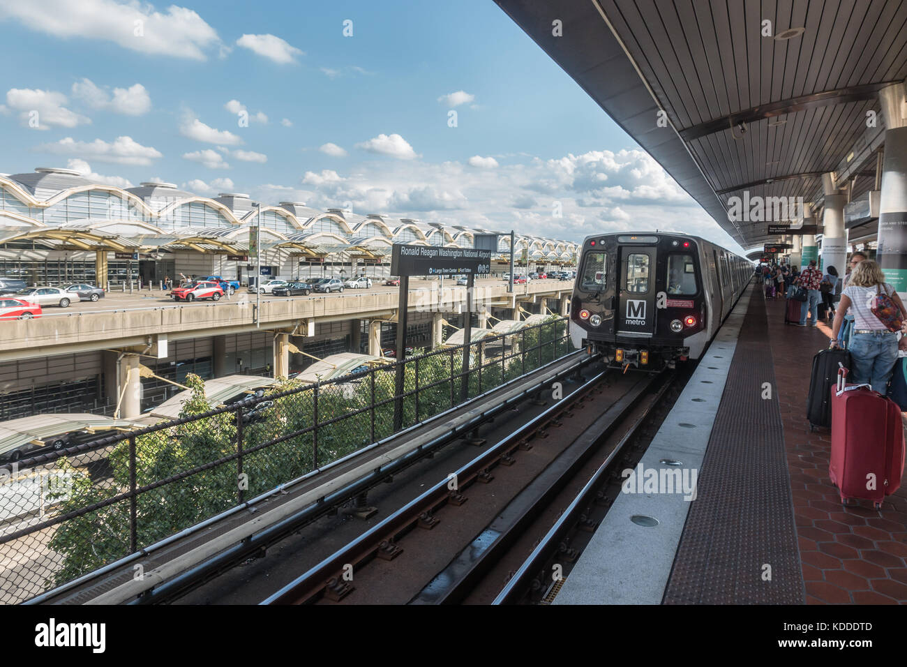 Terminal in background, Reagan National Airport Metro station with travelers.. Washington Metro station is served by Blue & Yellow Line trains, Stock Photo