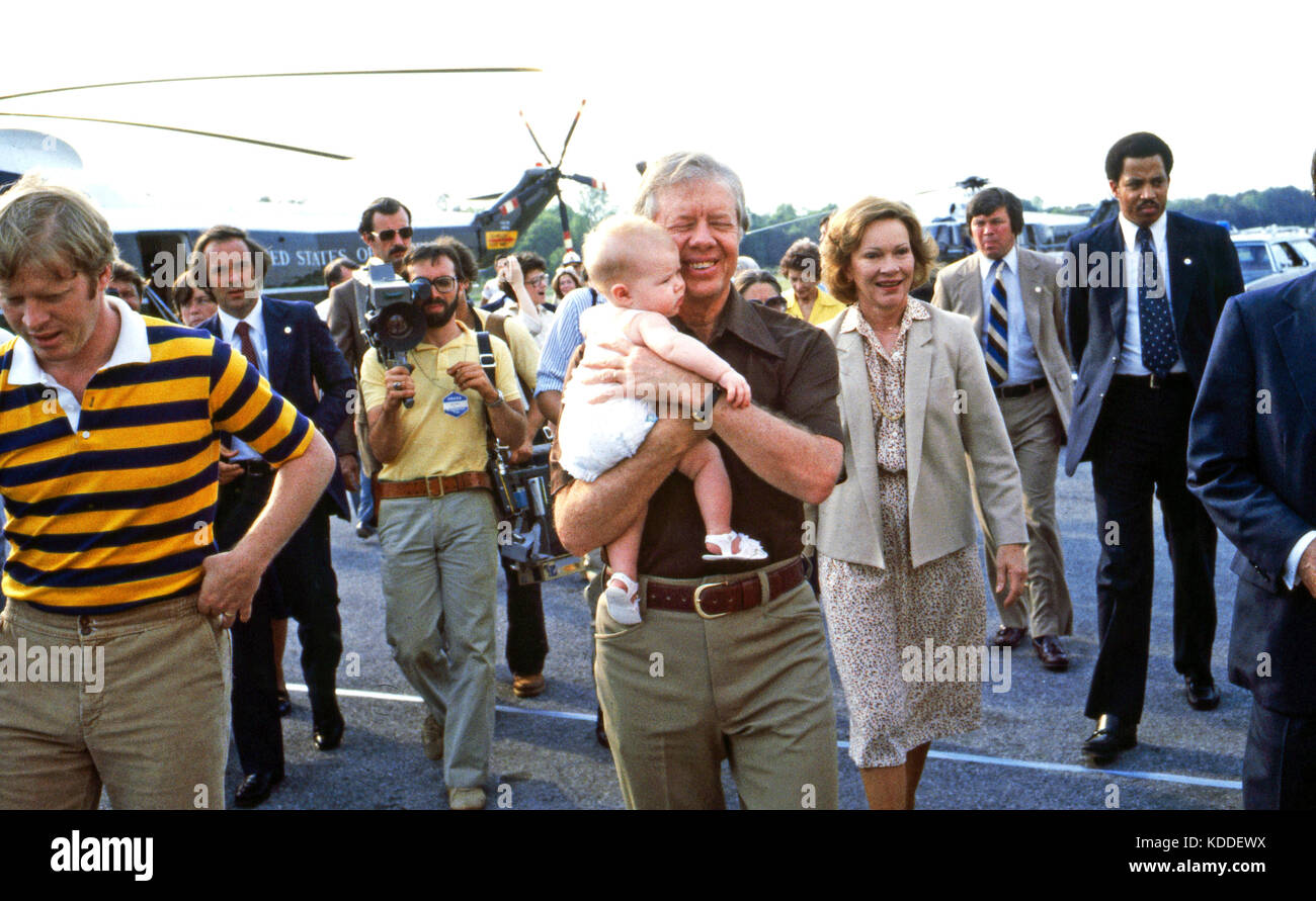 President Jimmy Carter, holds grandchild by son Jack (left