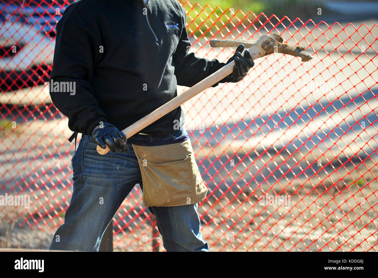 A worker holding a pick-axe on a building site in Canada. Stock Photo