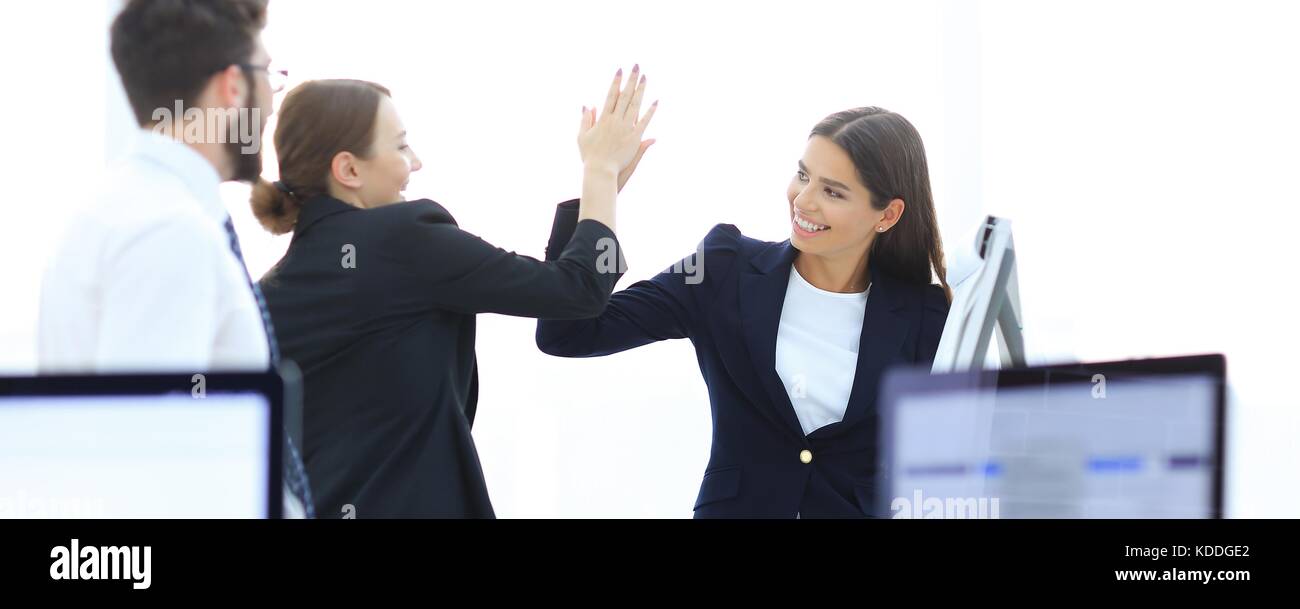 employees giving each other high five Stock Photo - Alamy