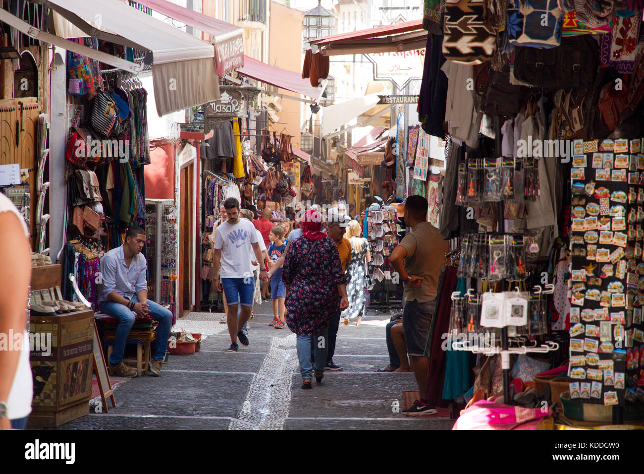 tourists exploring alley ways selling goods and souvenirs, Granada Spain Stock Photo