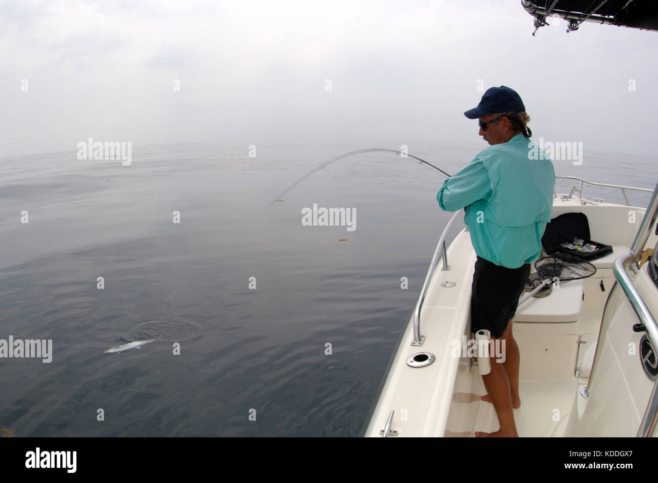 A fisherman with a kingfish or king mackerel caught while fly fishing