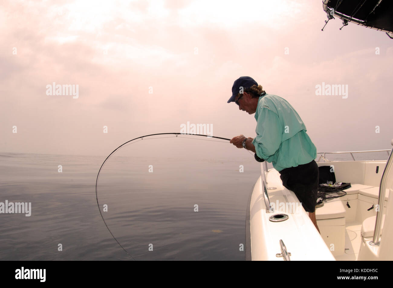 A fly fisherman fights a big fish while fishing offshore from Freeport