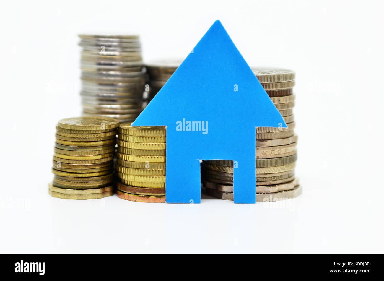 Blue paper house model and stacks of coins Stock Photo - Alamy