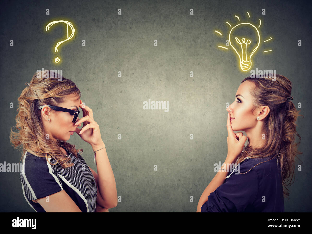 Two women thinking one has a question another solution with light bulb above head isolated on gray background. Stock Photo