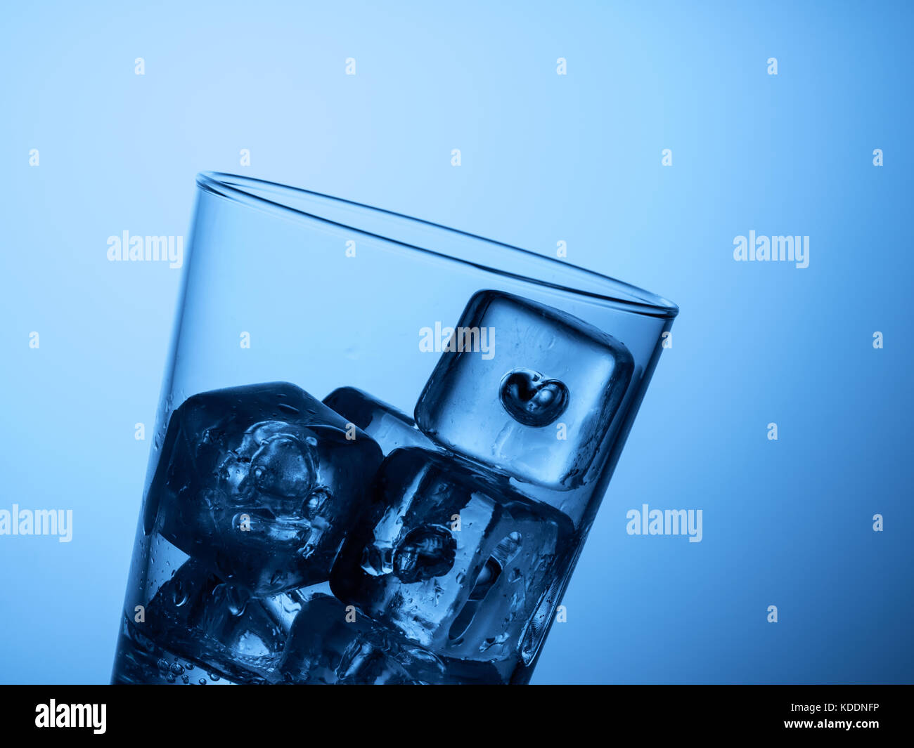 top of a glass of water with ice cubes on a light blue background Stock ...