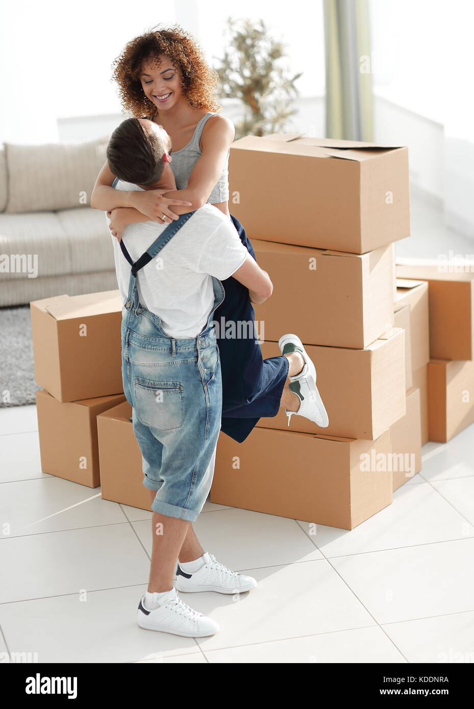 Portrait of a young couple moving into a new home Stock Photo - Alamy