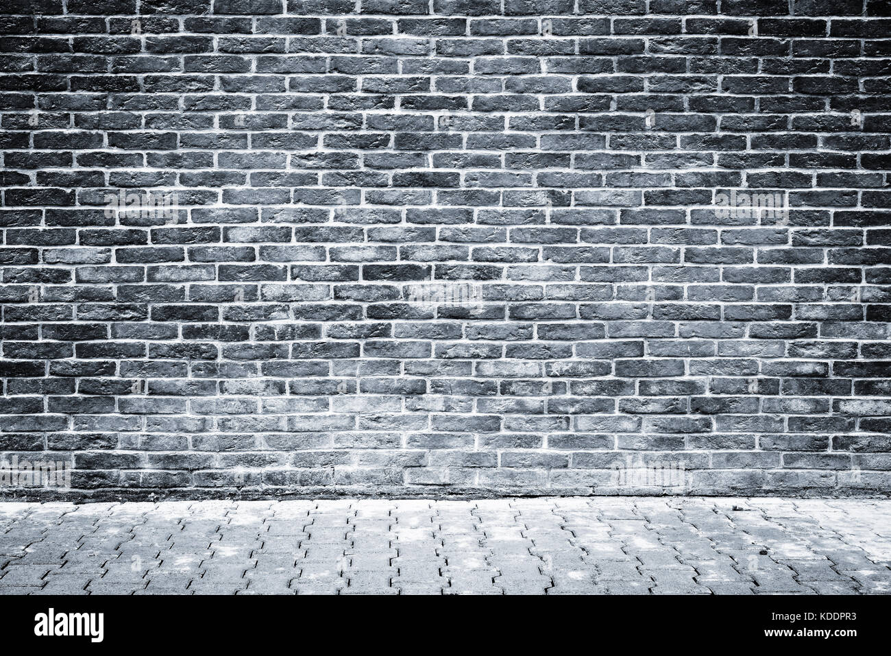 Monochrome image of the brick wall and stone floor background Stock ...