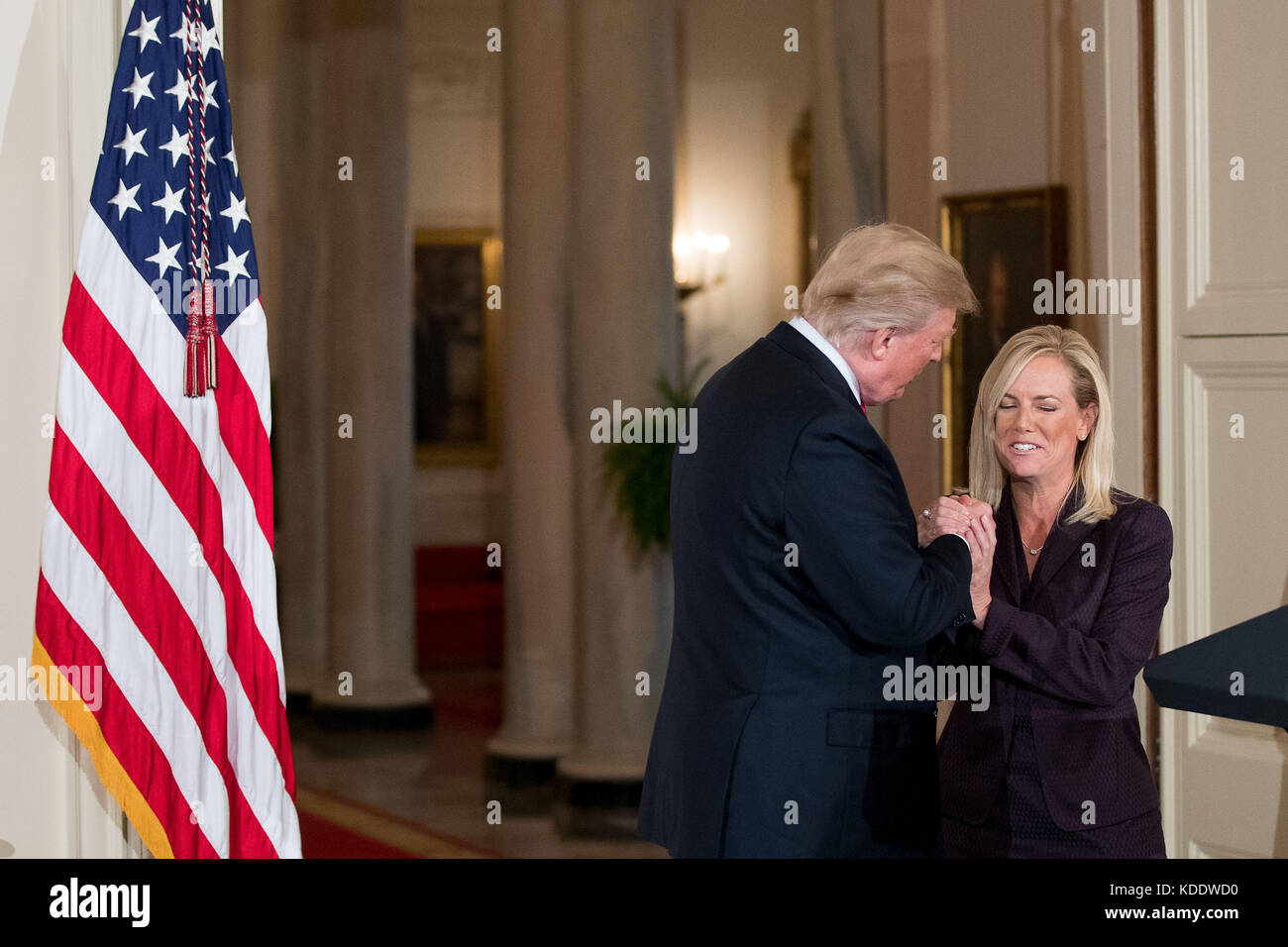 Washington, USA. 12th Oct, 2017. U.S. President Donald Trump (L) shakes hands with Kirstjen Nielsen during her nomination announcement at the White House in Washington, DC, the United States, on Oct. 12, 2017. Trump on Wednesday nominated Kirstjen Nielsen, an aide to White House Chief of Staff John Kelly, to be Secretary of Homeland Security. Credit: Ting Shen/Xinhua/Alamy Live News Stock Photo