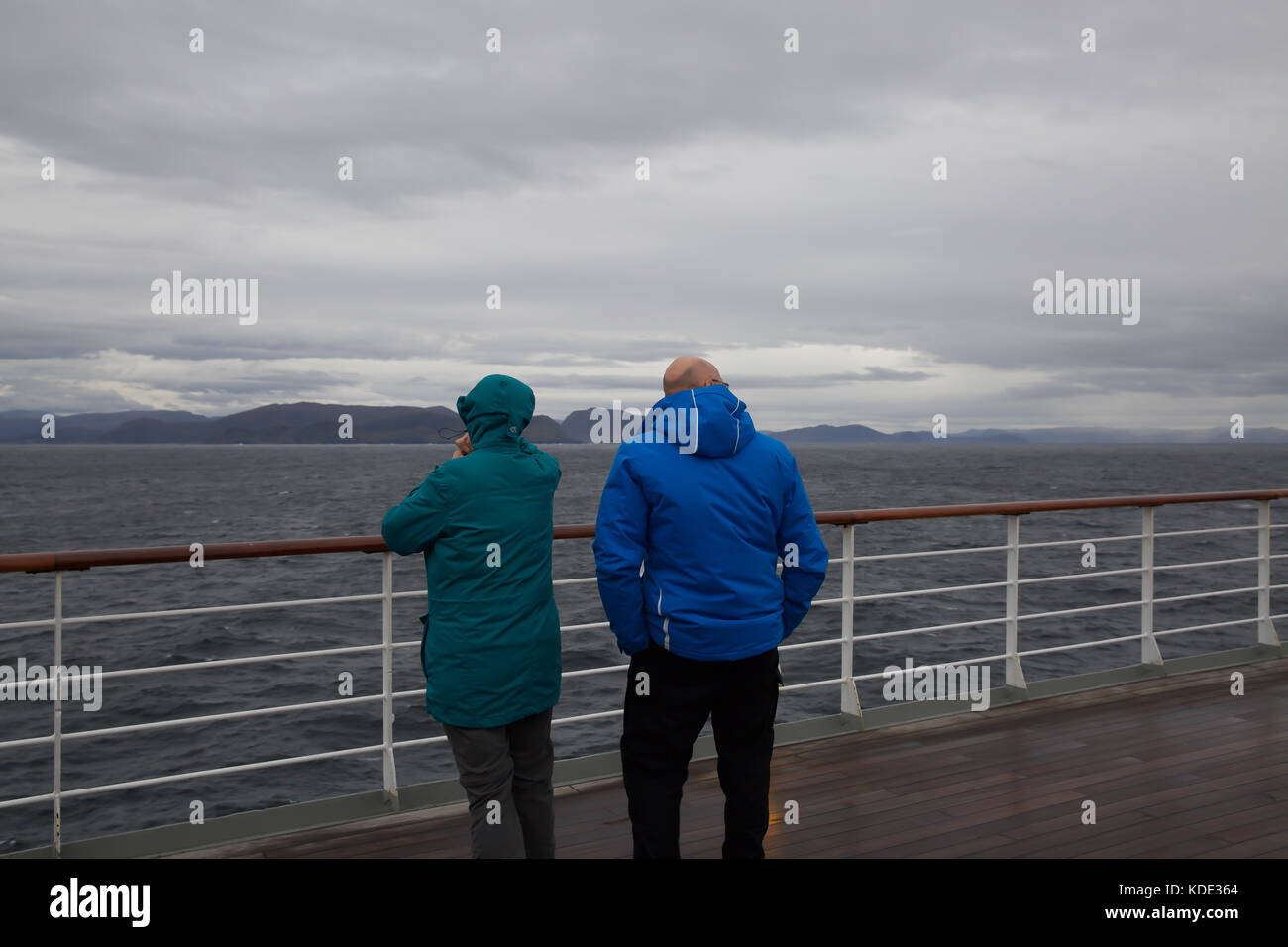 Alesund, Norway. 13th October, 2017. Cloudy and Grey skies over Magellan as it approaches Alesund in Norway. People on board wrap up warm against the inclement weather as they view the scenery passing by. © Keith Larby/Alamy Live News Stock Photo