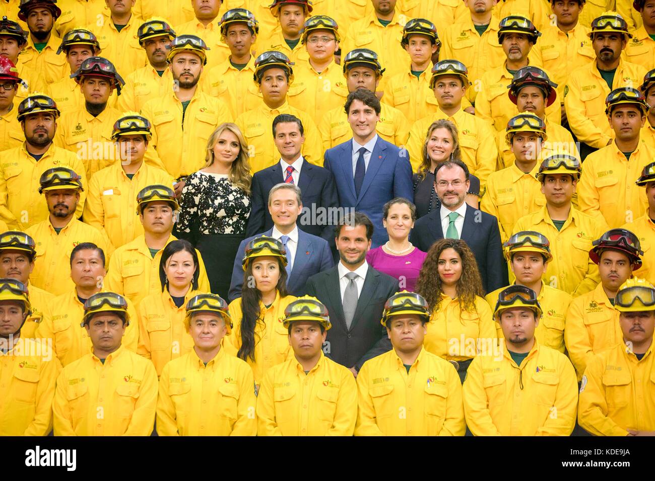 Canadian Prime Minister Justin Trudeau and his wife Sophie Gregoire Trudeau, right, stand with Mexican President Enrique Pena Nieto, and his wife Angelica Rivera for a group photo with Mexican firefighters, who helped to fight Canadian forest fires at Palacio Nacional October 12, 2017 in Mexico City, Mexico.   (presidenciamx via Planetpix) Stock Photo