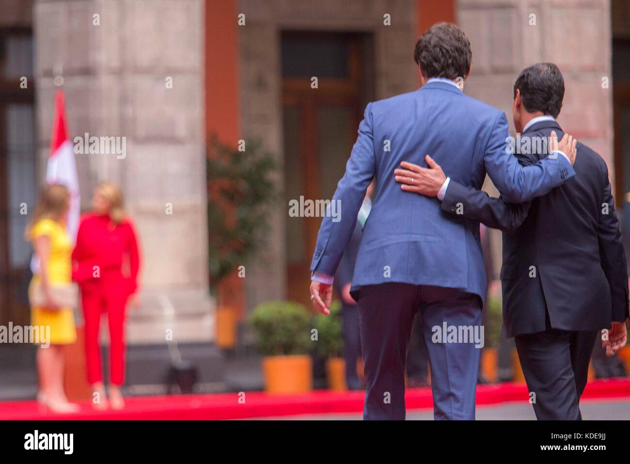 Canadian Prime Minister Justin Trudeau and Mexican President Enrique Pena Nieto walk together arm and arm following the formal arrival ceremony at Palacio Nacional October 12, 2017 in Mexico City, Mexico.   (presidenciamx via Planetpix) Stock Photo