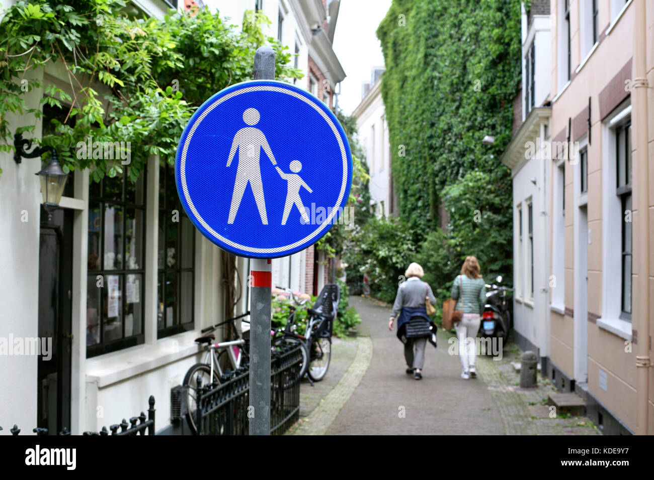 A 'pedestrian only' sign indicates a traffic-free street in Haarlem, North Holland. Stock Photo