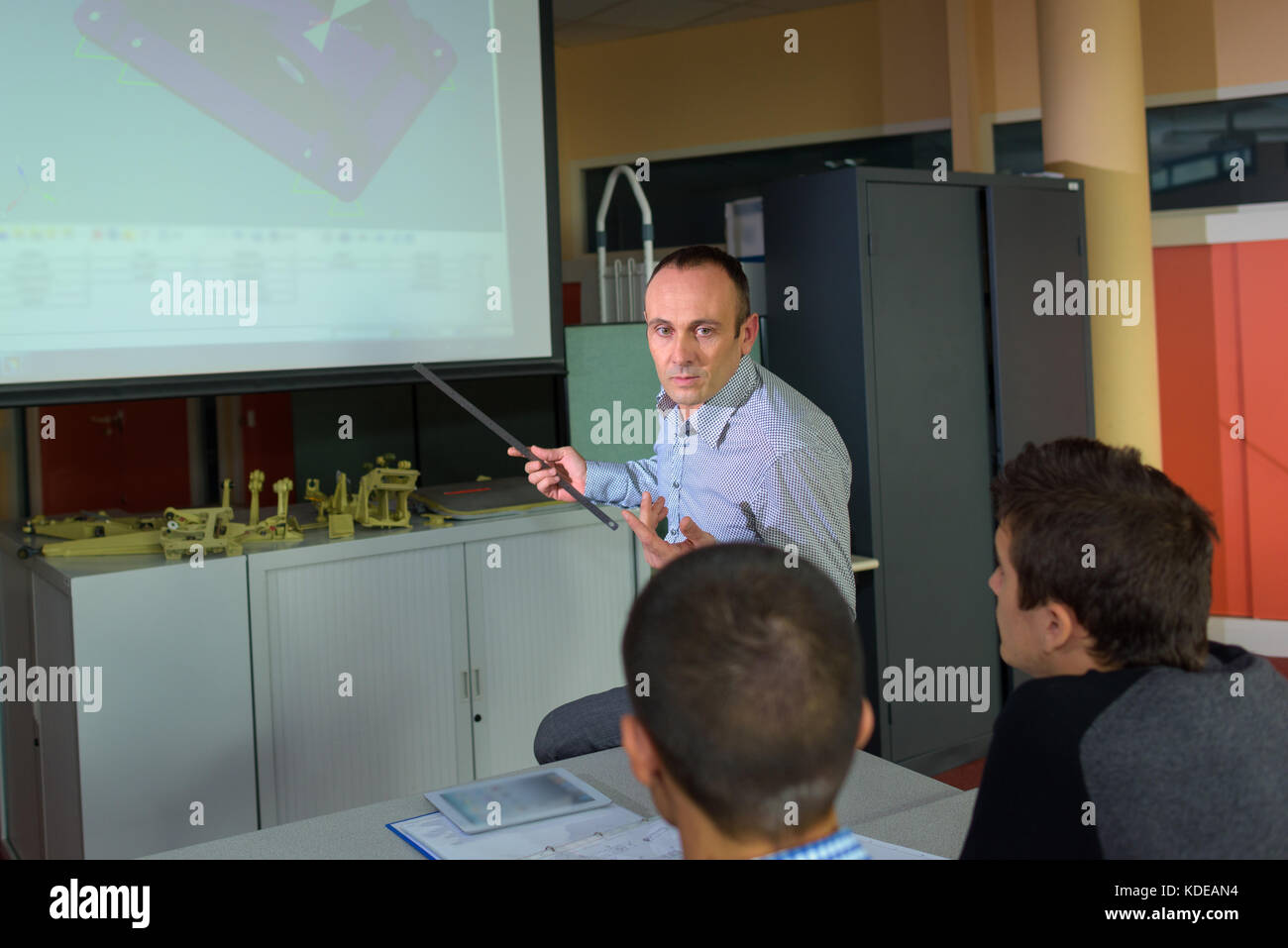 Teacher showing projector images to students Stock Photo - Alamy