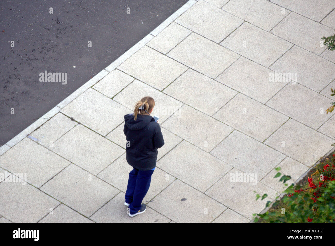 Queen Elizabeth University Hospital,Royal Hospital for Children, patients on path from above woman female girl worker on smart phone Stock Photo