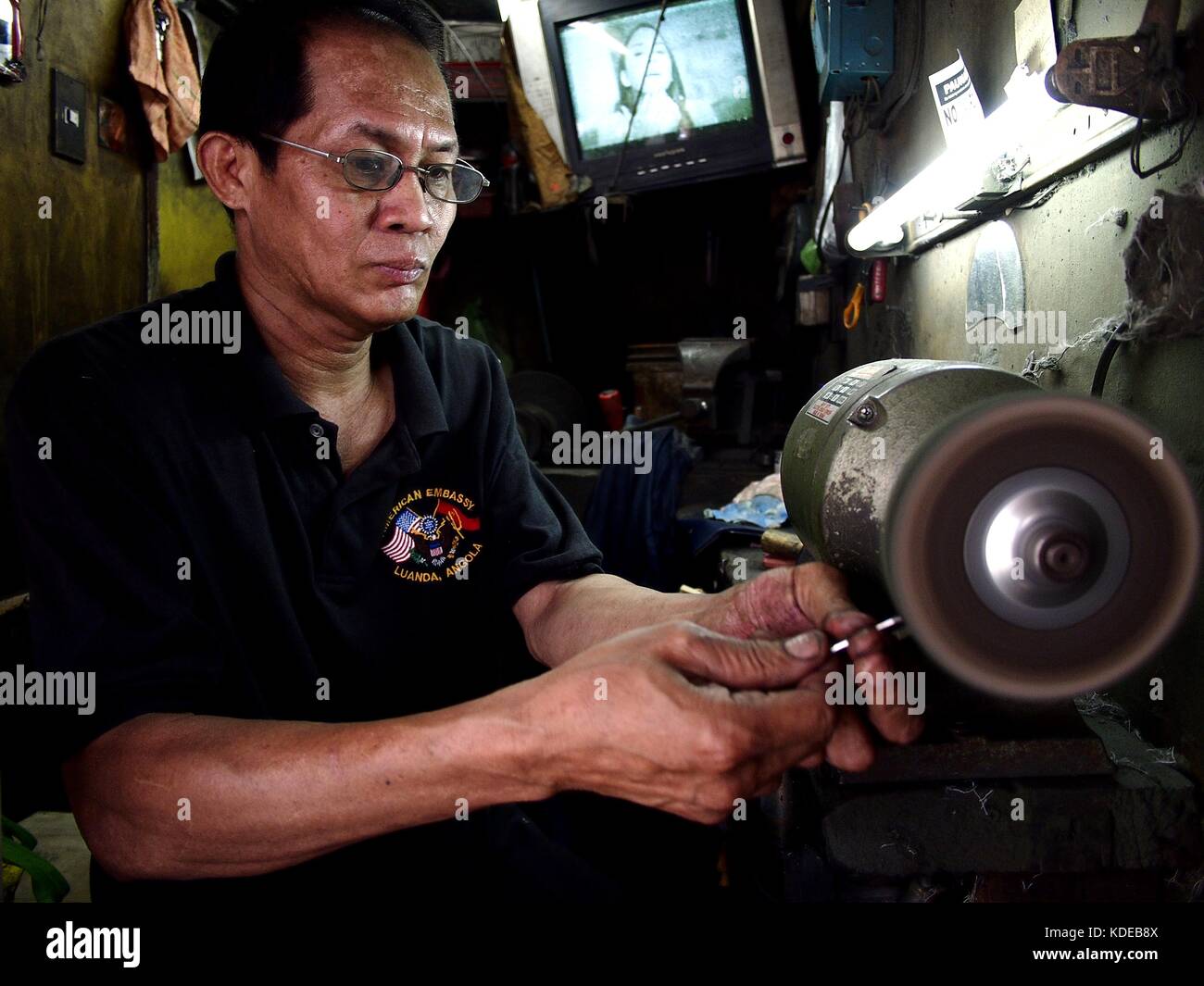 ANTIPOLO CITY, PHILIPPINES OCTOBER 12, 2017 A worker sharpens a