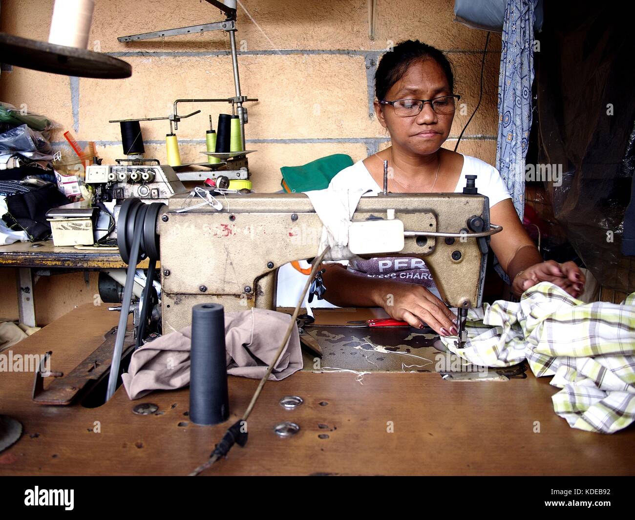 ANTIPOLO CITY, PHILIPPINES - OCTOBER 11, 2017: A dressmaker works