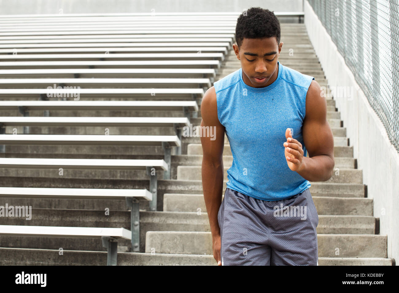 Teenage athlete running the bleachers Stock Photo Alamy