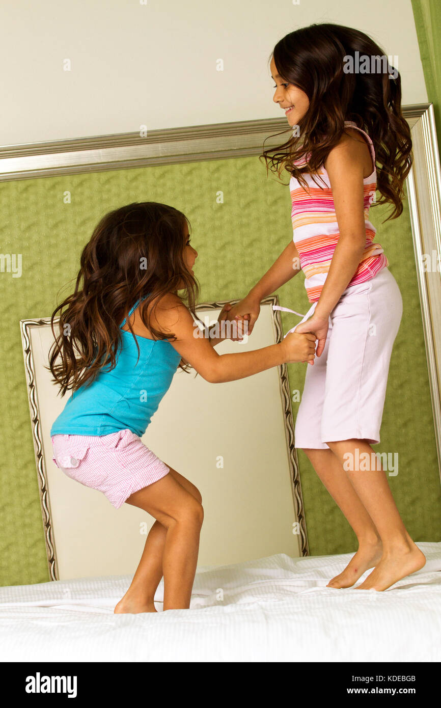 Kids laughing jumping on the bed. Stock Photo