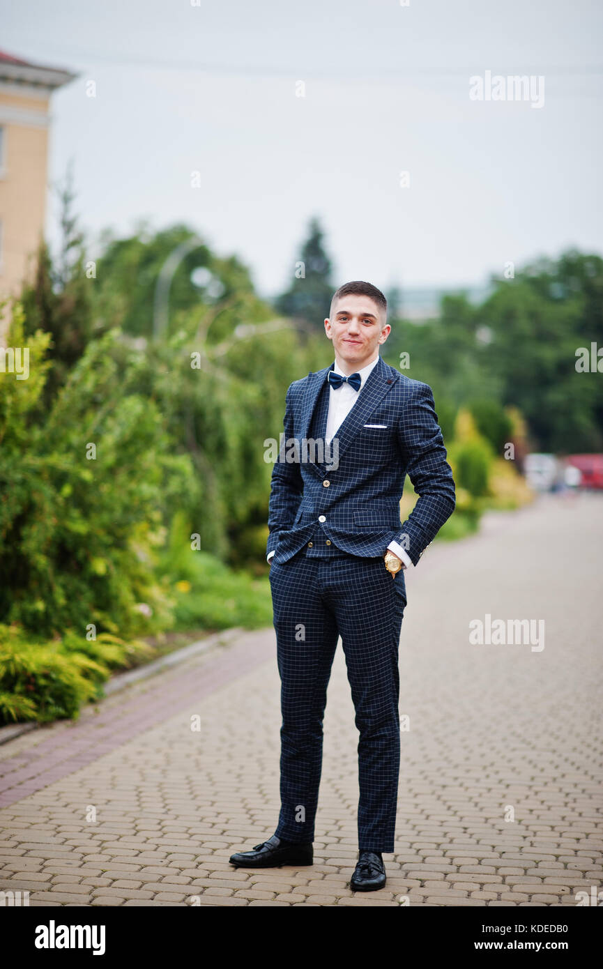 Sexy handsome male model posing in blue fashion suit and white style shirt  looking down on dark shadow background. Toned portrait Stock Photo | Adobe  Stock