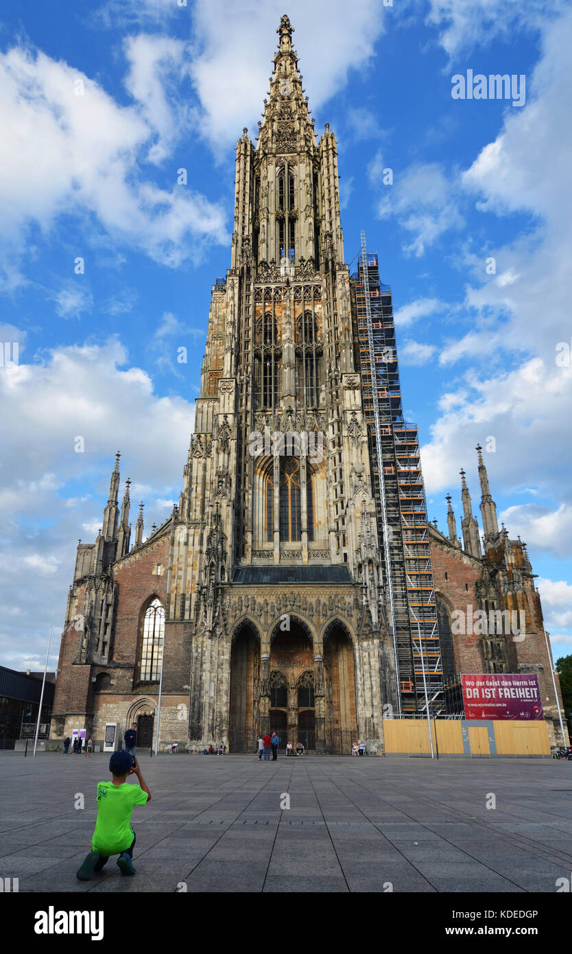 Ulm, Germany - 28th July 2017: Boy taking picture of Ulm Minster (Ulmer Münster) Stock Photo