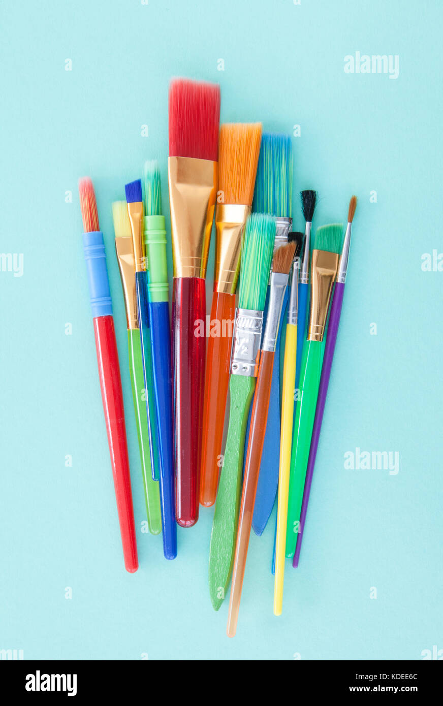Colorful paint brushes on a blue background Stock Photo - Alamy