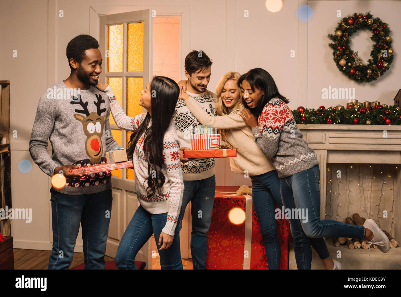 multicultural friends exchanging christmas gifts Stock Photo Alamy