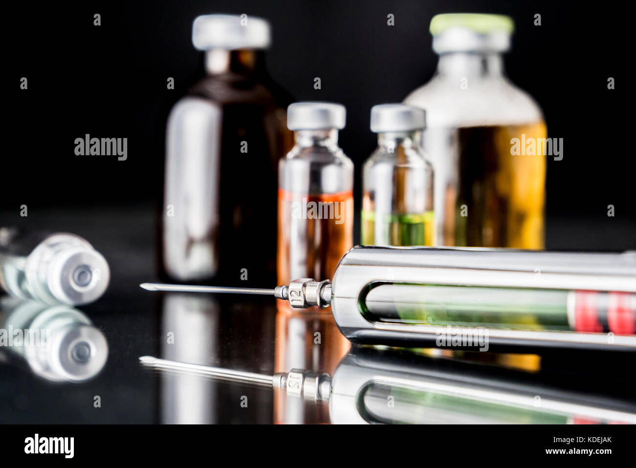 Several vials and syringe in laboratory, conceptual image Stock Photo ...