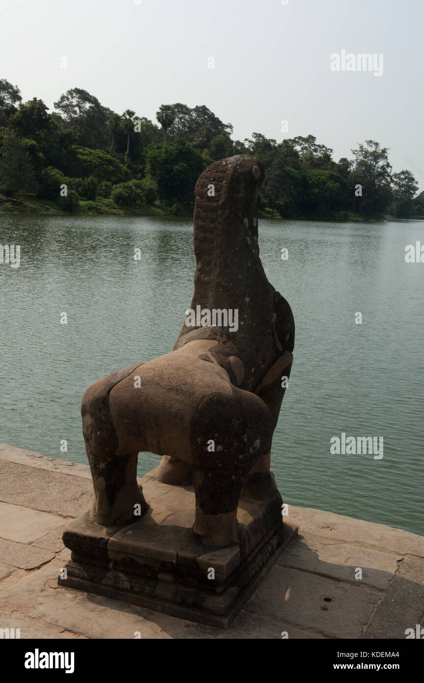 Stone Demon by the edge of the temple lake at Angkor Wat Stock Photo