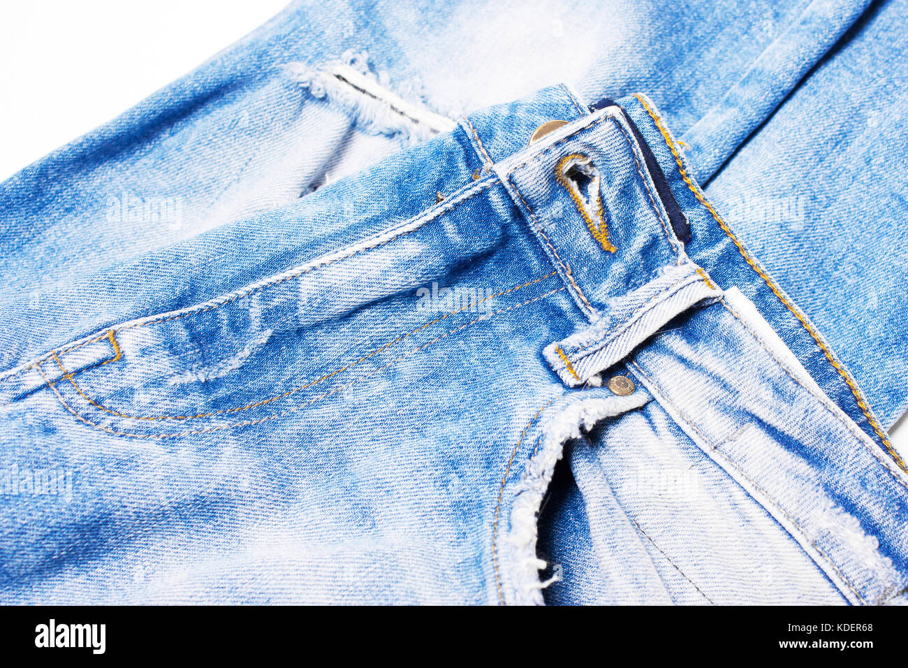 Blue jeans closeup on white background, texture of denim Stock Photo