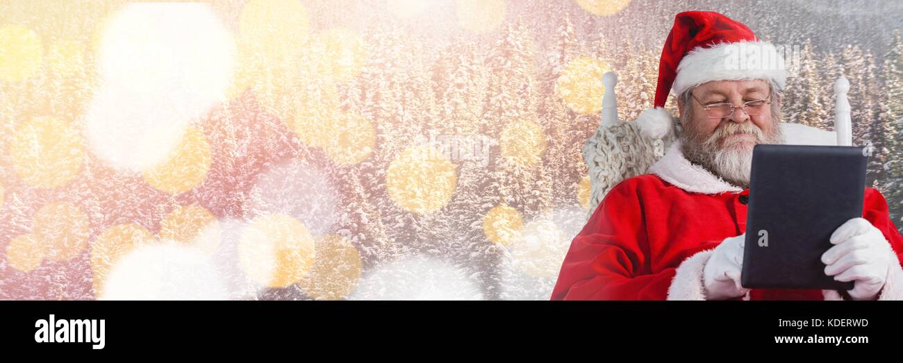 Digital composite of Santa with Winter landscape using tablet Stock ...