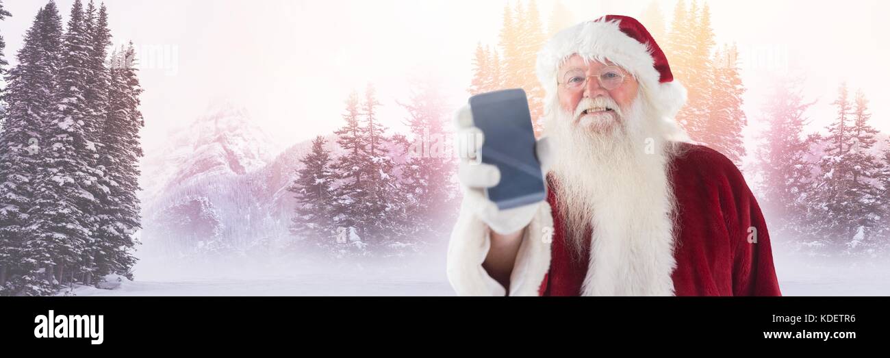 Digital composite of Santa Claus in Winter with phone Stock Photo - Alamy