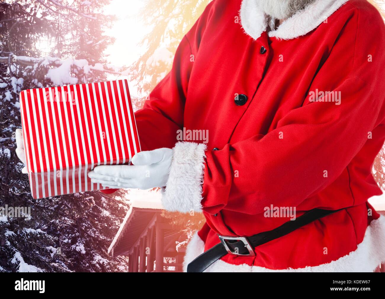 Digital composite of Santa Claus in Winter with gift Stock Photo - Alamy