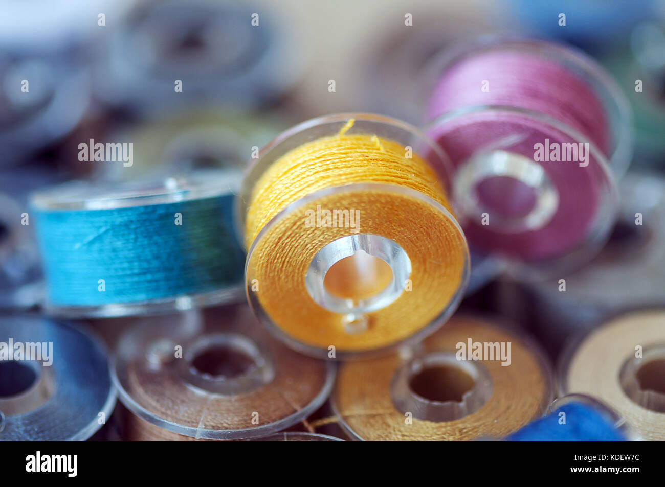 Close-up on colored sewing threads on spools Stock Photo - Alamy