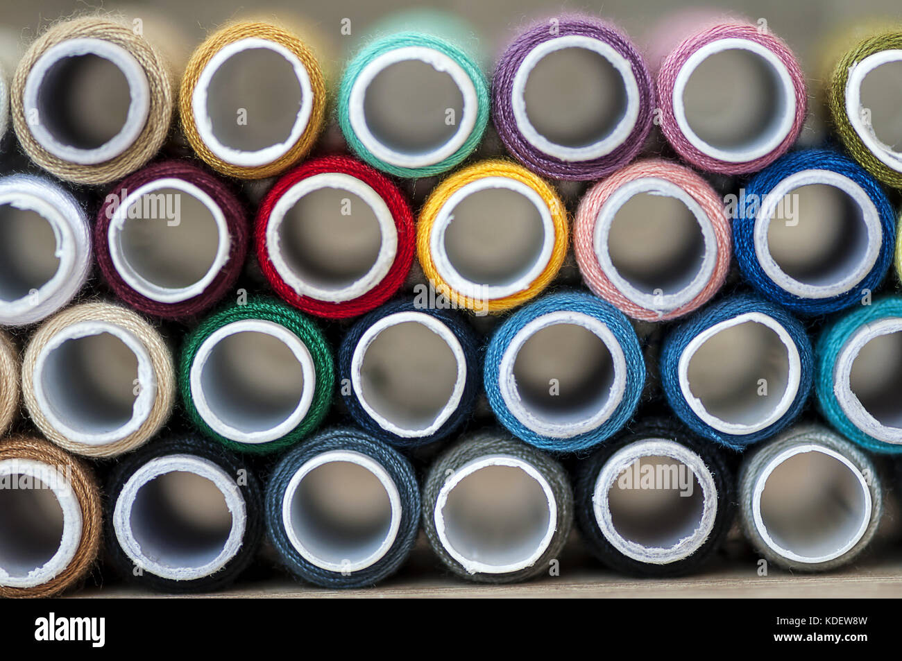 Close-up on colored sewing threads on spools Stock Photo - Alamy
